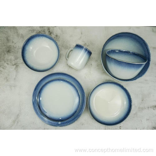 Reactive glazed stoneware dinner set with blue rim